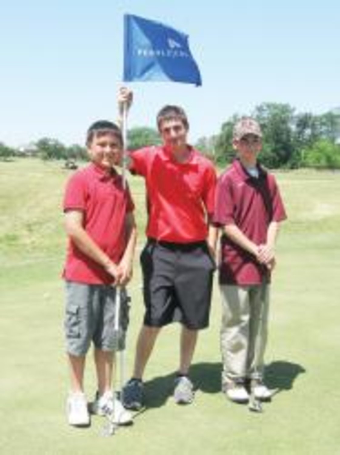 Wood County 4-H members Greyson Cox, Zachary Finch, and Gabe Brunson pose on the green in College Station during the 4-H Golf Challenge Camp in April.