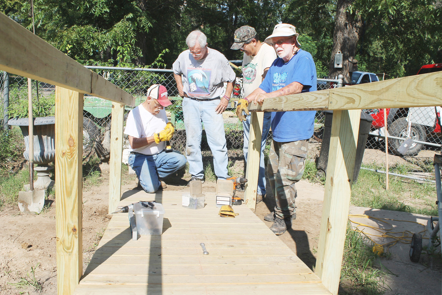 Members of the Methodist Men had already been at work a couple of hours in the mid-morning sun when they were observed building a ramp on a McWhorter Street house Wednesday. The ramp is for an elderly woman who was no longer able to get in and out of her house. Shown are, from left, Charlie Wright, Art Gould, Ed Castro and Roy McGee.