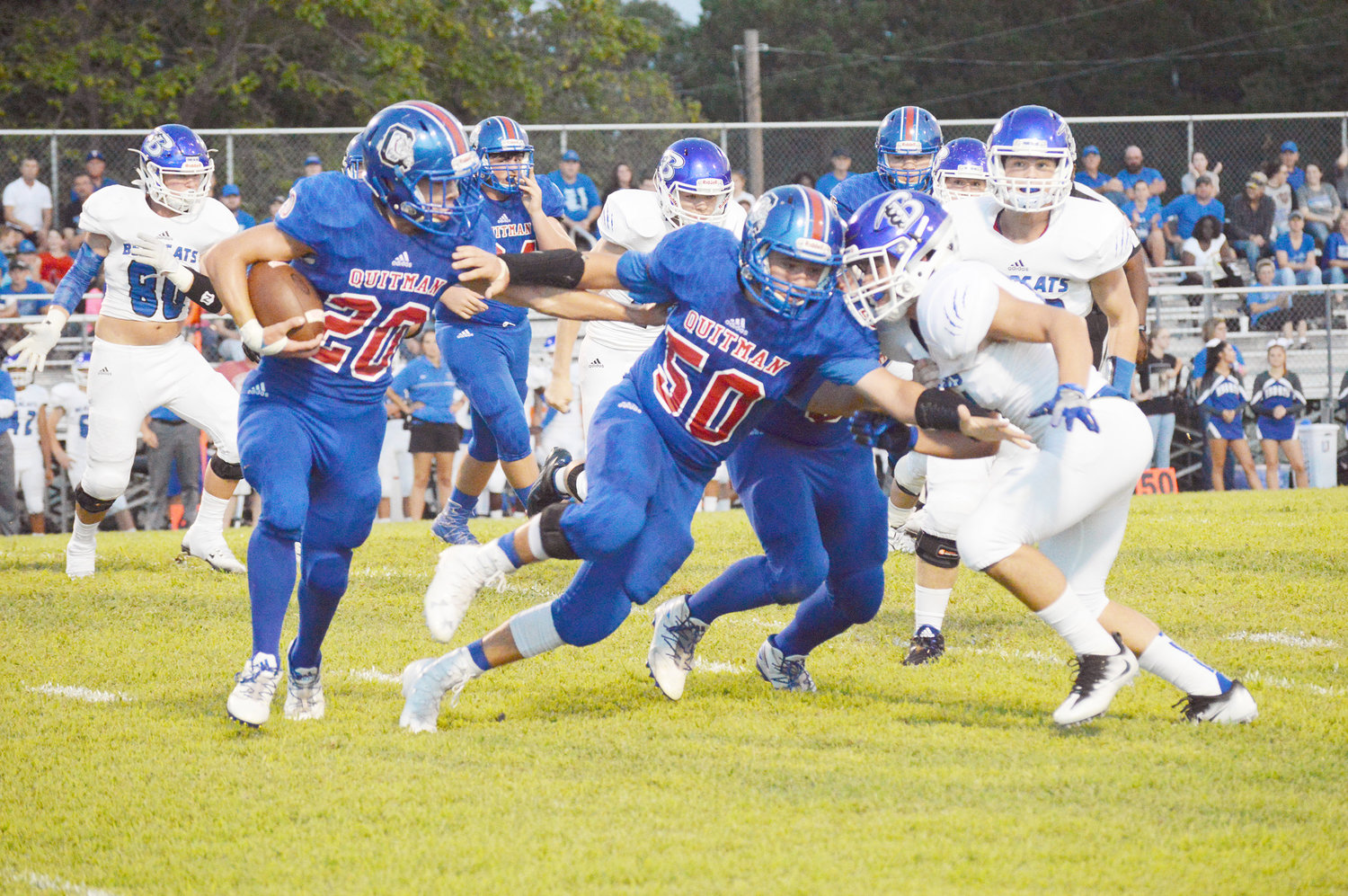 Quitman’s Teague Stewart (50) leads the way for Bulldog running back Kayden White. (Monitor photo by Larry Tucker)