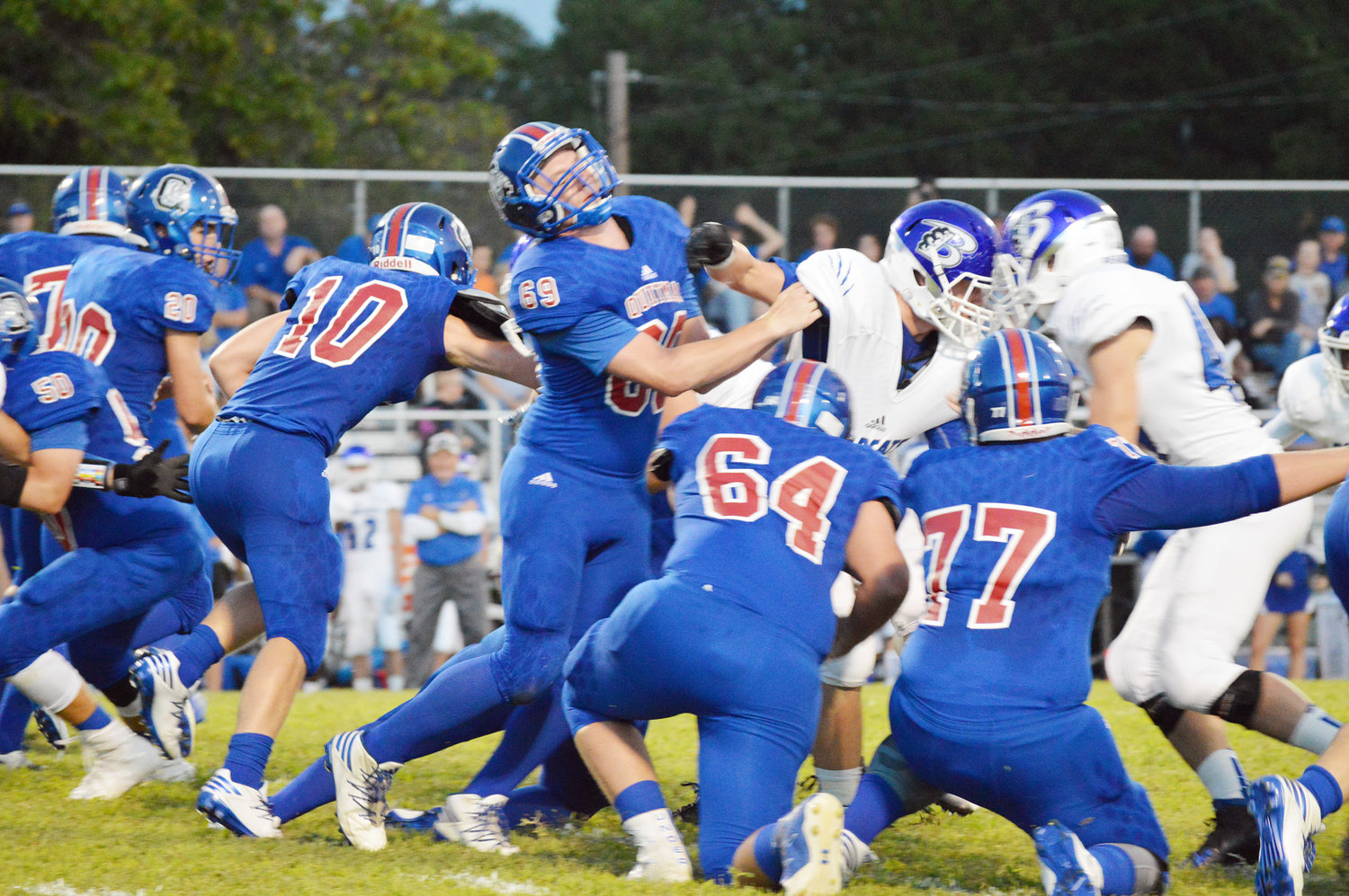 A.J. Dunn (10) finds running room behind the efforts of linemen Aaron McDade (69), Sebastain Howell (64), and Gage Tolle (77) in Friday’s game against Beckville. (Monitor photo by Larry Tucker)