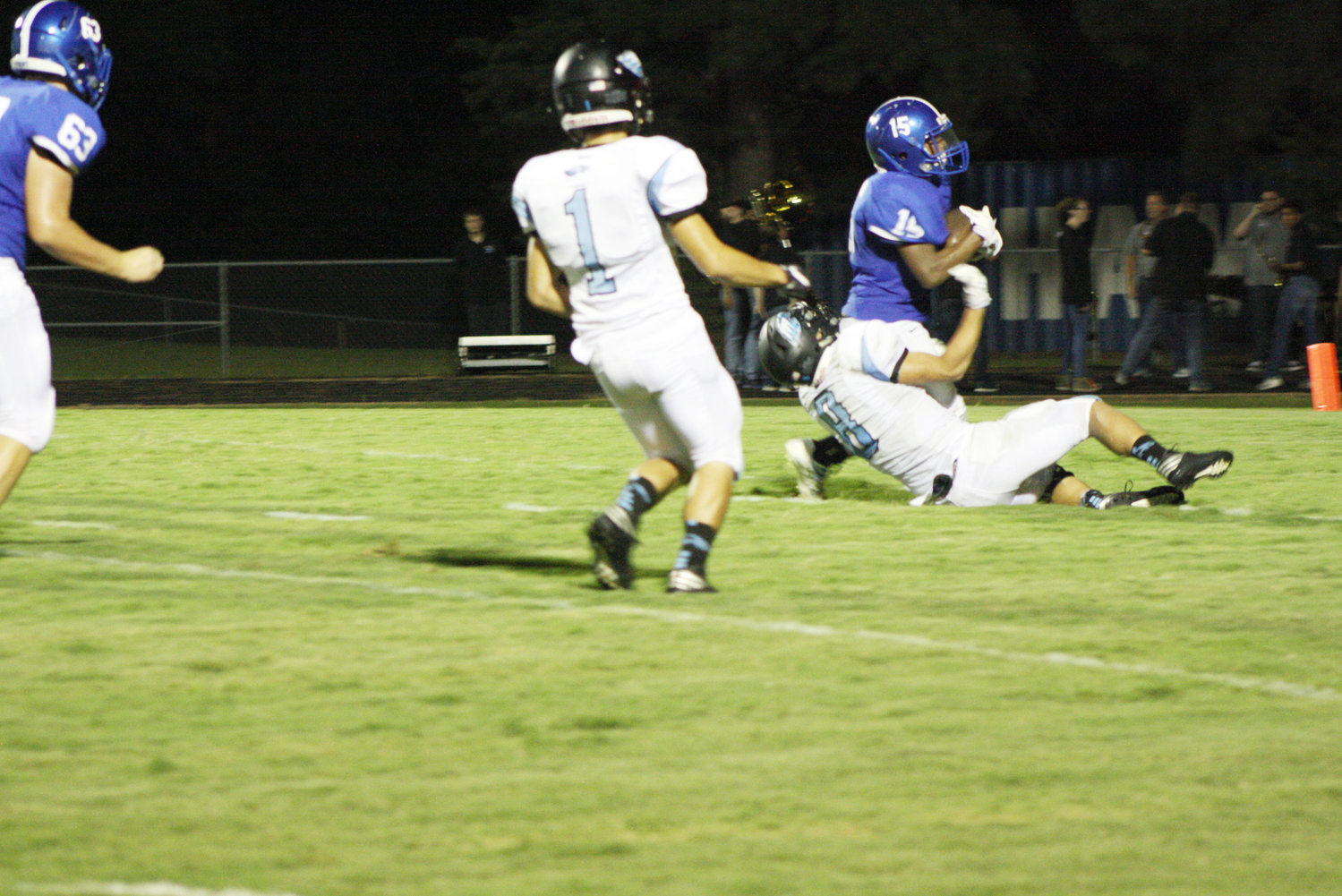 Hawk receiver Everin Gipson struggles to retain possession against Como defenders.  (Photo courtesy of Taylor Jones)