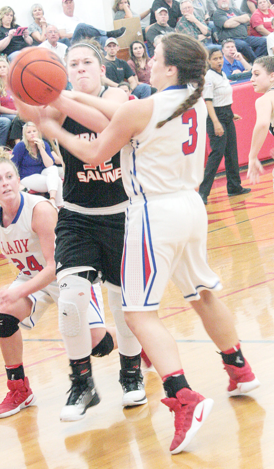 Concentration is evident in the eyes of Alba-Golden’s Shelby Wright (3) and Grand Saline’s Payton Stanley (32) as they present a tangle of arms and hands while battling for a rebound in last Tuesday’s District 13-3A game at Alba.