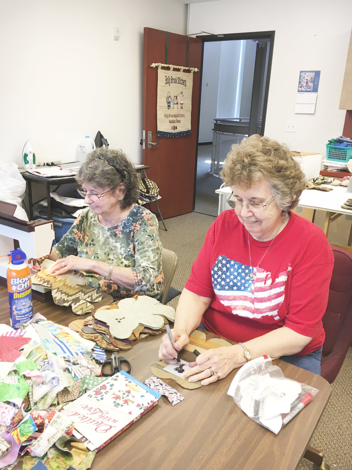 Pat Cude, right, and Dixie Marsh of Holly Brook Baptist Church near Hawkins add finishing touches to two of the 240 toy bears constructed by women of the church. Cude is leader of Holly Stitchers.