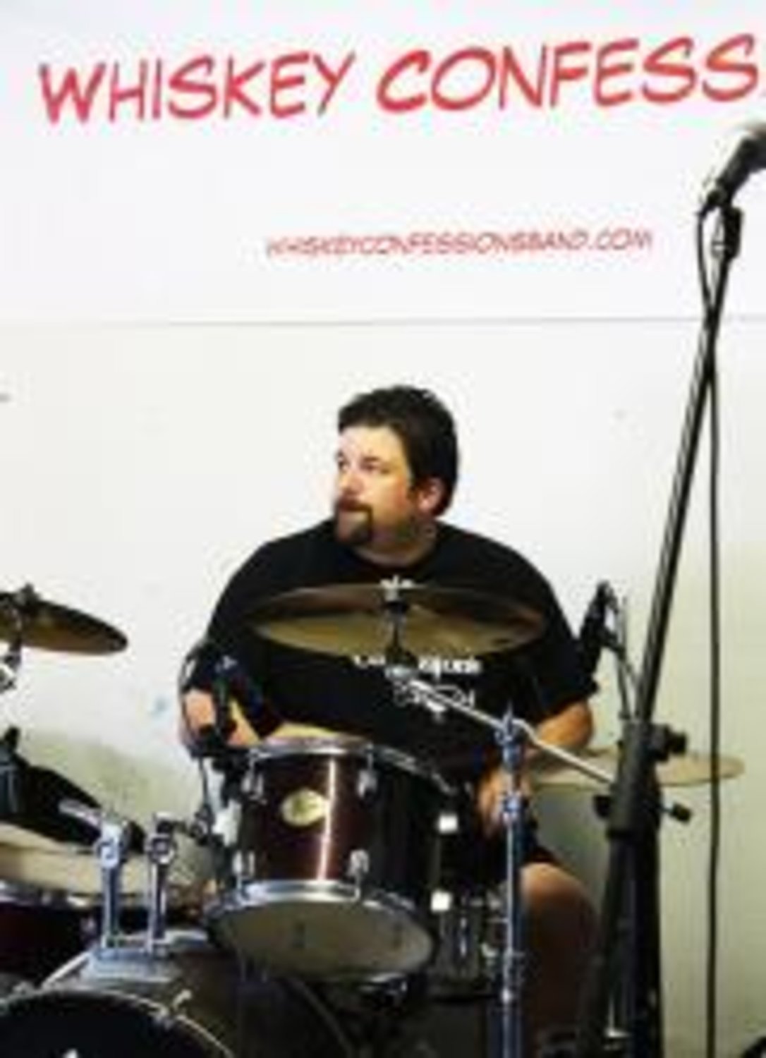 Charles Sharpe, who lives in Canton, Texas, keeps the beat for Whiskey Confessions Band during a rehearsal.
