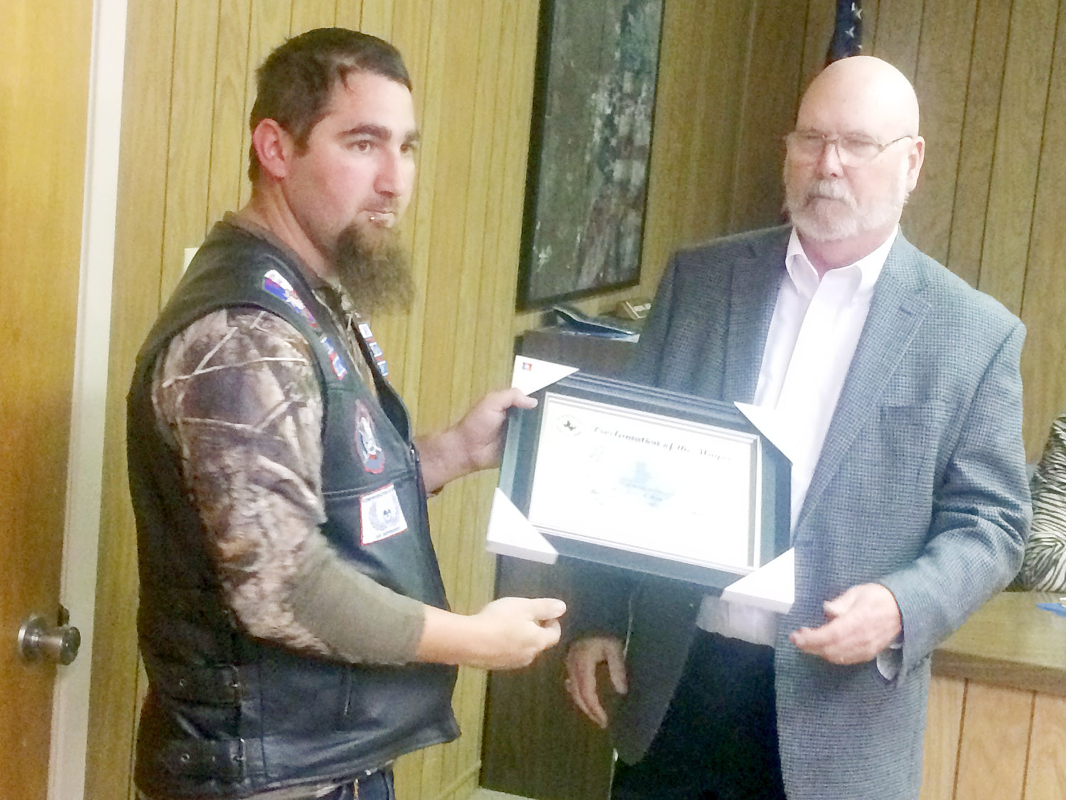 Quitman Mayor J.R. Evans (right) gives Steven Edwards (left) of Highway Masters Riding Club a proclamation honoring this upcoming May as Motorcycle Safety and Awareness Month.