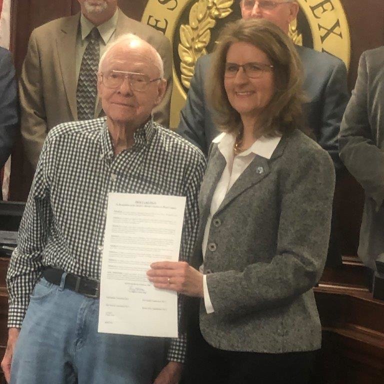 Dr. David C. Murley of Winnsboro is pictured here with Wood County Judge Lucy Hebron being honored with a proclamation by Wood County commissioners for his years of service as a dedicated and compassionate physician and for his almost 50 years as the county medical director.