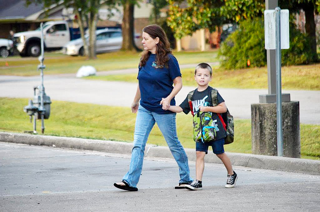 Monday morning was the first day of classes at Quitman ISD. Elementary student Kristopher Minter was walked to school by his mother, Kelli Minter, to begin the new year. (Monitor photo by Larry Tucker)