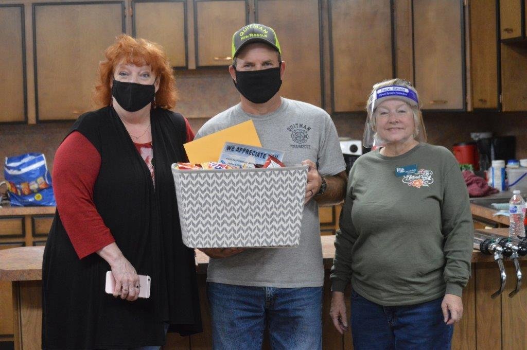 The Mineola League of Arts (MLOTA) made up snack baskets for first responders throughout Wood County and made deliveries on Friday, including the Quitman Fire Department. From left are Nell French (MLOTA secretary), Quitman Fire Chief Scotty Wheeler and MLOTA President Jan Sokolosky.