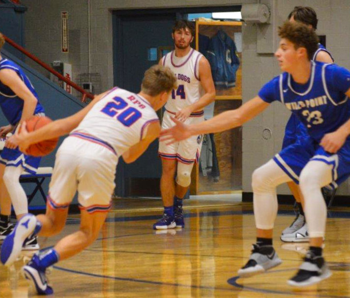 Brady Floyd (20) drives from the top of the key as Aiden Corrior looks for a dish.