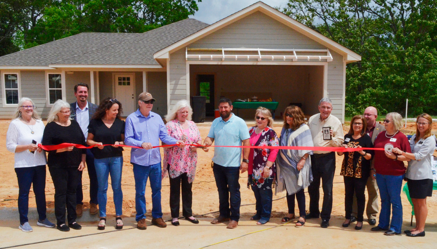 City officials joined builder Peter Woolford, members of the Blackmon family and real estate agents for a ribbon cutting at Blackmon Meadows last Wednesday in Mineola.