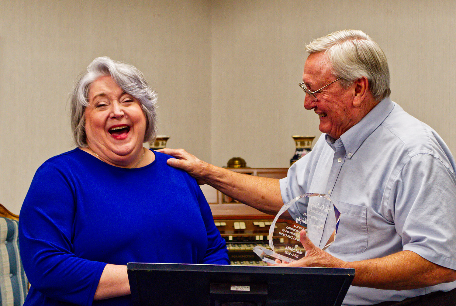 John Fuller gets a laugh from Nancy Murphy during her retirement reception at the Mineola Civic Center.