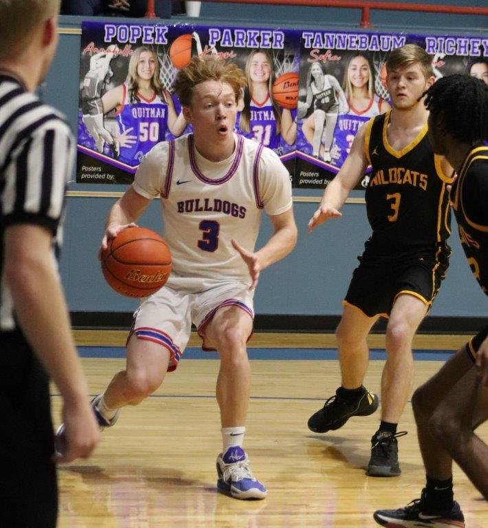 Quitman’s Hunter Jacobs (3) drives the baseline against Winona in the Bulldogs’ 47-34 win last week.