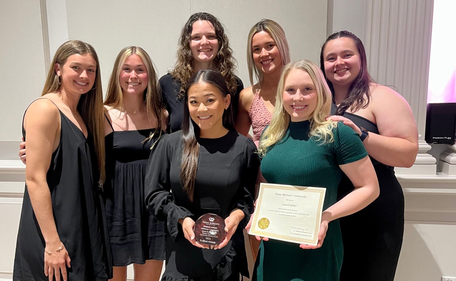 Laurel Jones, front right with certificate, served as president of the Student Athlete Advisory Committee at TWU which was honored for community service.