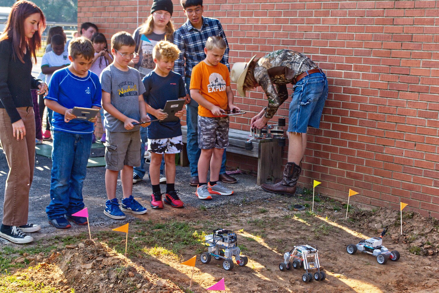 Students race robot vehicles over a course during the annual Science Extravaganza Friday morning at Mineola Elementary School. Some 19 outdoor and 17 indoor exhibits were set up.