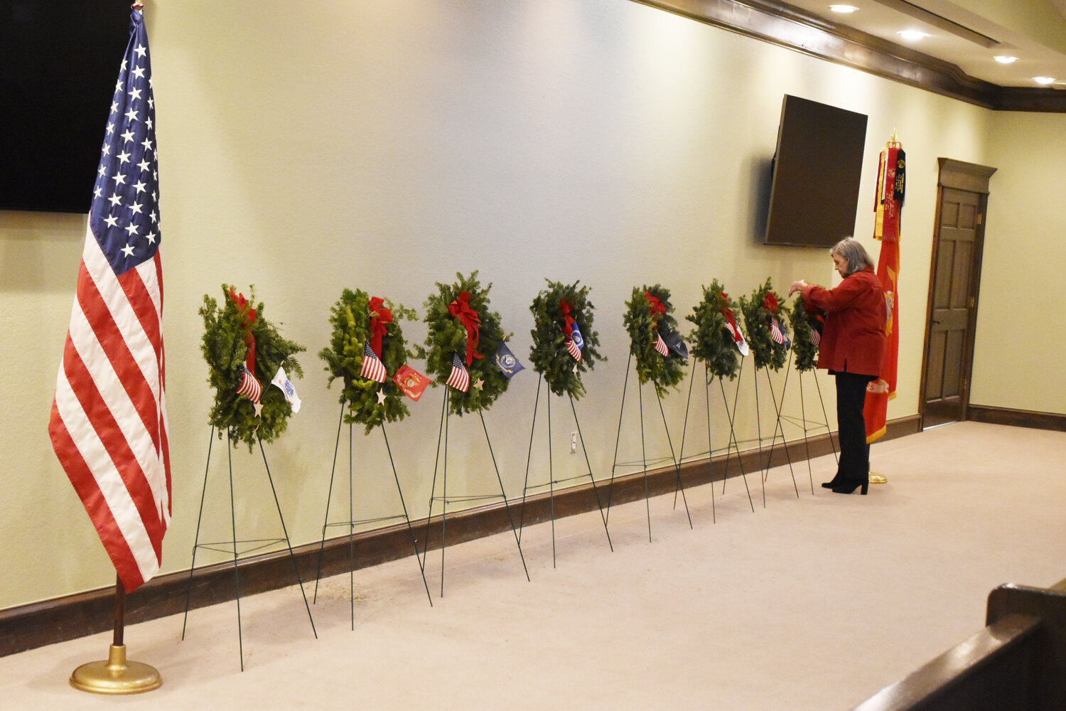 Barbara Vogl places a wreath in honor of POWs and MIAs.