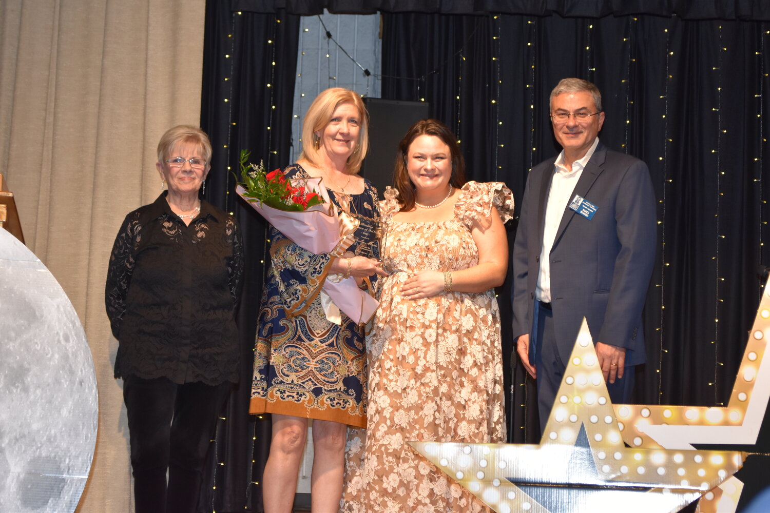 The Woman of the Year was awarded to Becky Moore, second from left, at last Thursday’s Mineola Chamber of Commerce banquet. From left are presenter Beth Shockey, Chamber President Kelsie McGilvray and Vice President Daren Beaudo.
