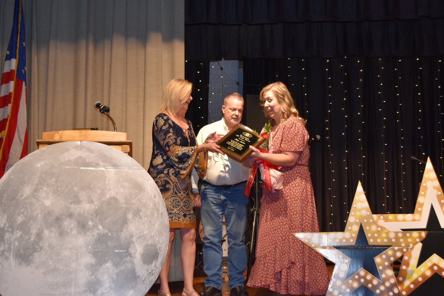 Kiwanis Club members Becky Moore, left, and President Brian Jones present the teacher of the Year Award to Lacy Smith, middle school history teacher, at the chamber of commerce banquet.