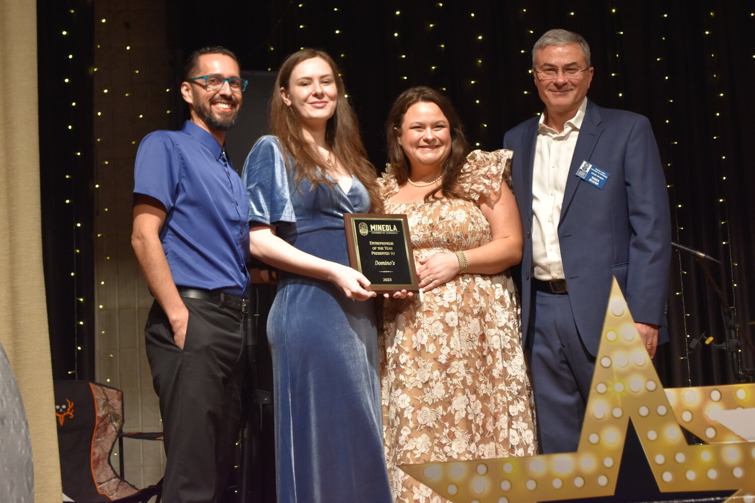 Jeramy Cruz  and Chelsey Clair with the new Dominoes Pizza franchise were awarded the Wayne Collins Entrepreneur of the Year award by the Mineola Chamber of Commerce. Presenting the award are Chamber President Kelsie McGilvray and Vice President Daren Beaudo.