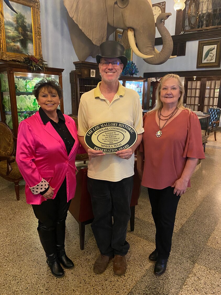 Mineola Landmark Commissioners Cheryl Wood, left, and Martha Holmes presented Chris Butler with the Lou Mallory Historic Preservation Award. He and his wife Sarah have restored the Beckham Hotel and Ballroom. The hotel has been a Mineola institution for over 100 years.