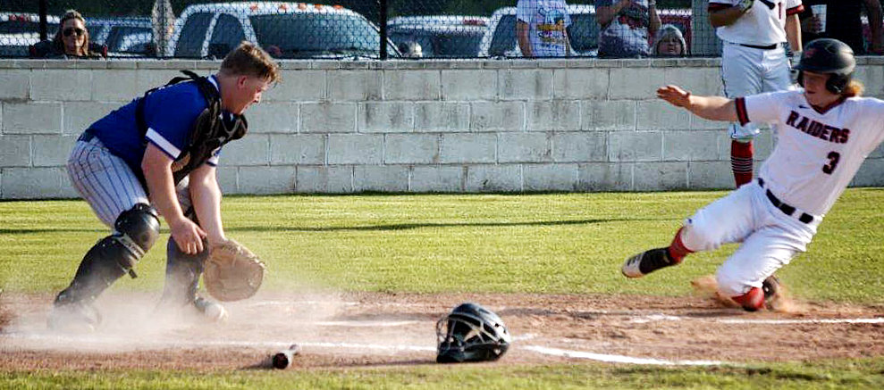 Quitman catcher Cody Hawley tries to dig a ball out the dirt in a close play at home against Winnsboro.