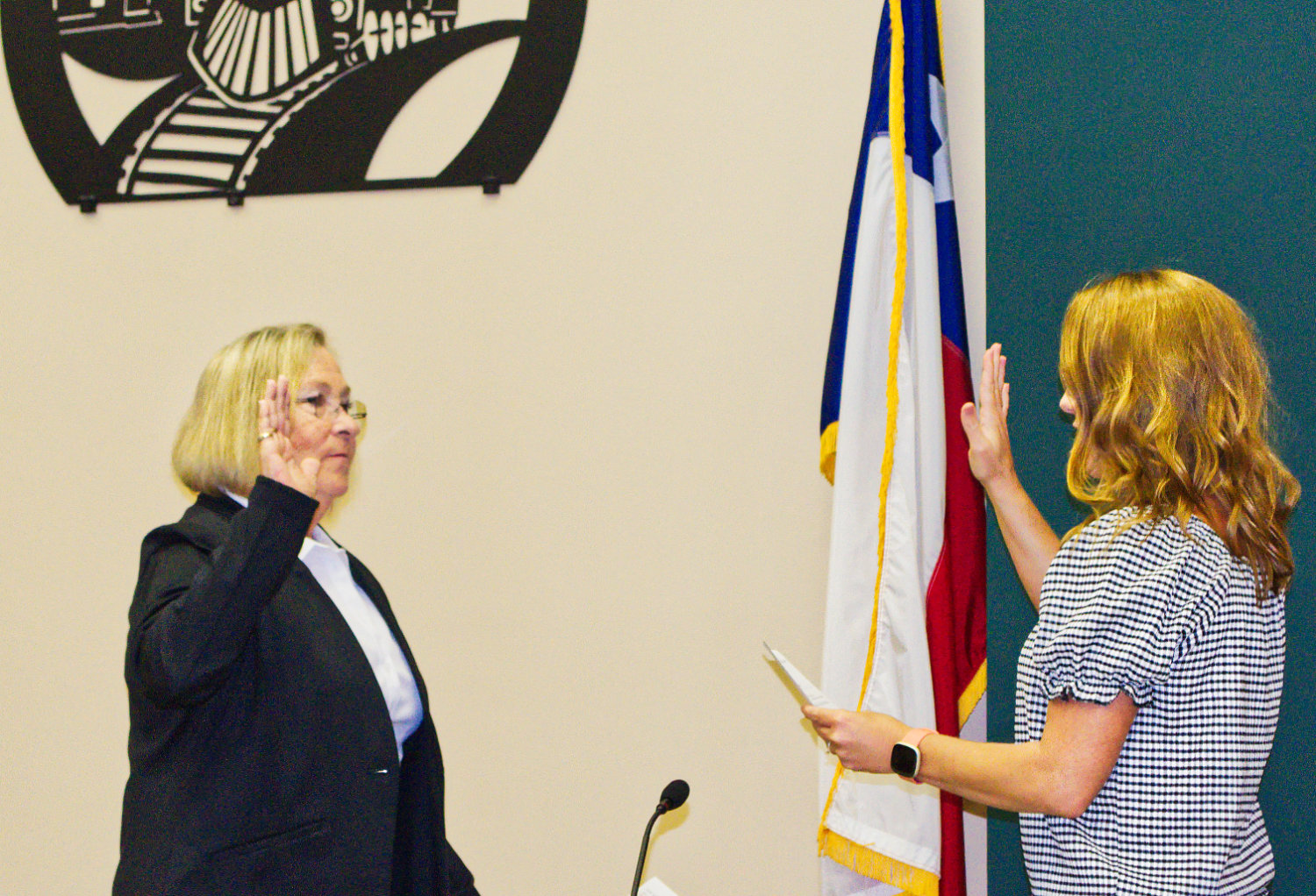 Jayne Lankford, left, is sworn in as mayor of Mineola Monday by City Secretary Cindy Karch.