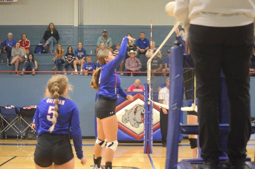 Quitman’s Kaysi Parker goes up high at the net to make a play for the Lady Bulldogs.