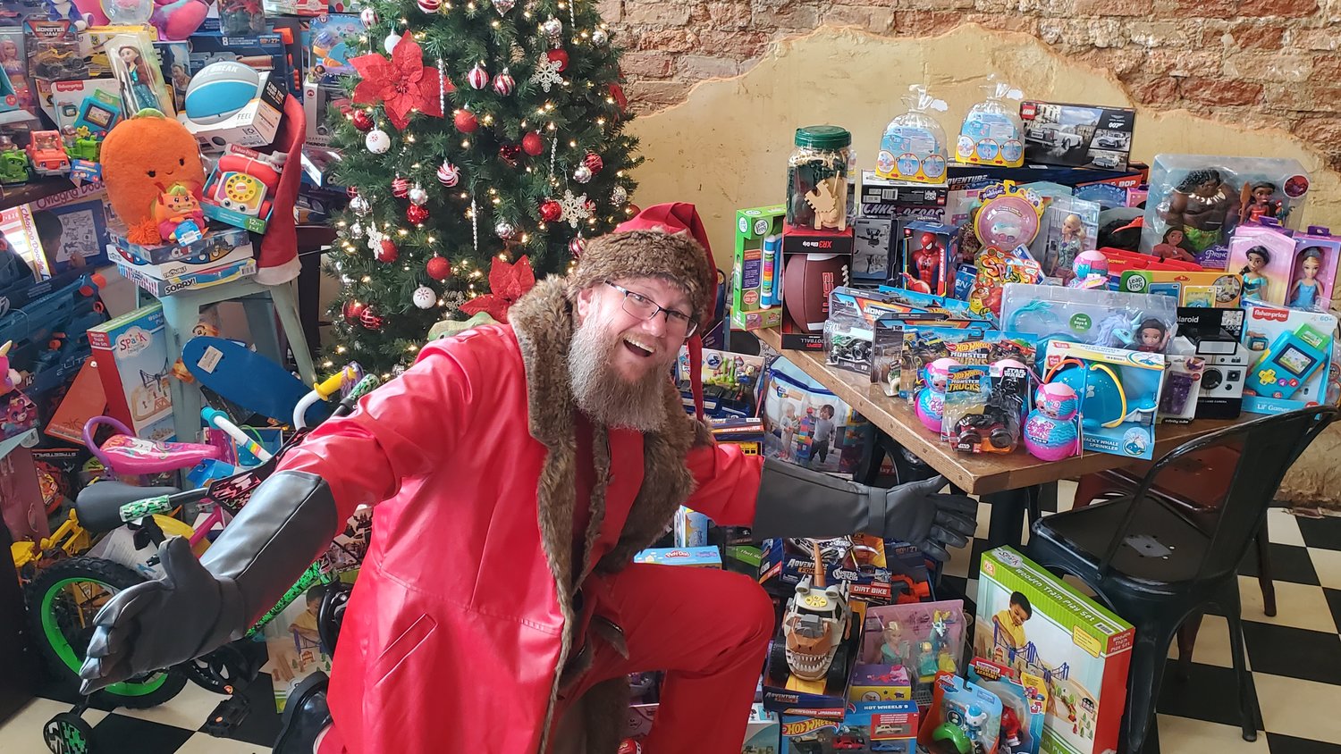 Jason Herring displays some of the toys gathered for the Toys for Tots program during a pub crawl held in downtown Mineola Dec. 17. Participants donated a toy, and additional donations were used to purchase more toys. Taking part were Cowburners, Kitchen’s, Logan’s Place, The Line and RNA Tavern. All the toys collected by Toys for Tots remain in Wood County. The program is a project of the Marines’ Toys for Tots Foundation.