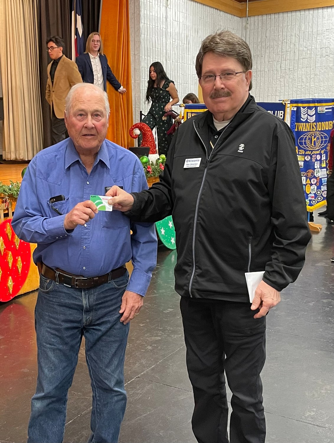 Caring and Sharing drive co-chair Roy Shockey presenting a gift card to Buck McGee.