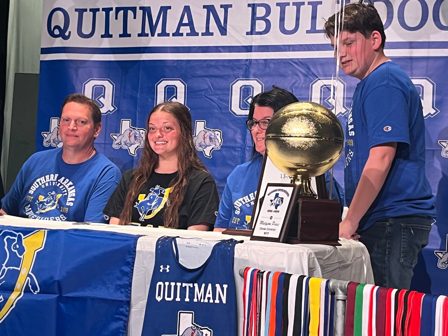 Quitman’s Maddy Pence signed a letter of intent last Thursday to attend Southern Arkansas University where she will run cross country and track. She is pictured with her family (from left) father Shannon Pence, Maddy, mother Mishea and brother Allen.

Pence also played varsity basketball, volleyball and softball during her four years at QHS. Cross Country Coach Mike Scott said Pence was “The foundation that helped build this program from just a few to over 30 girls who now are involved in cross country.”