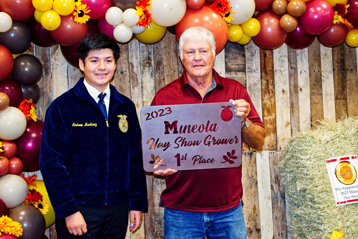 First-place hay grower Jim Hooton receives his plaque from Andrew Martinez.