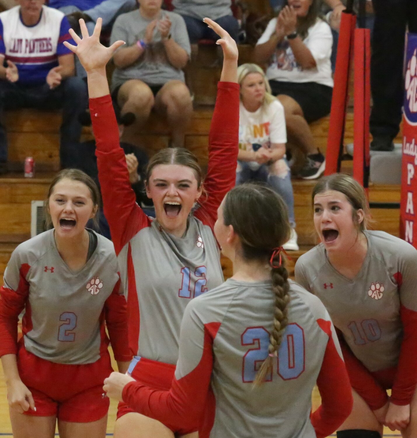 Lady Panthers Kalli Trimble (2), Alexis Wilmut (12), Hailey Crutchfield (20) and Lainey Teel (10) celebrate the first district match win last Friday.
